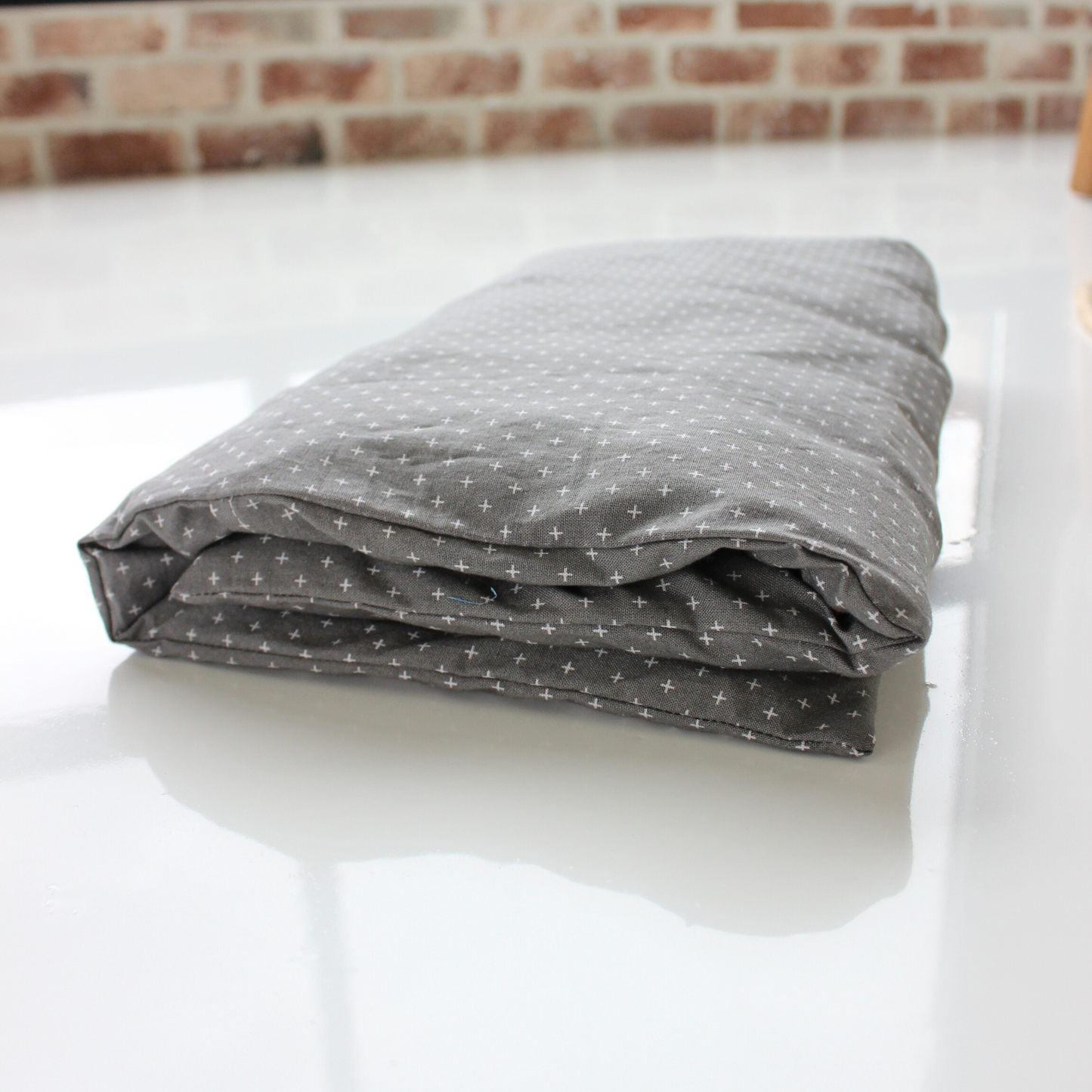 large gray heat pad folded up