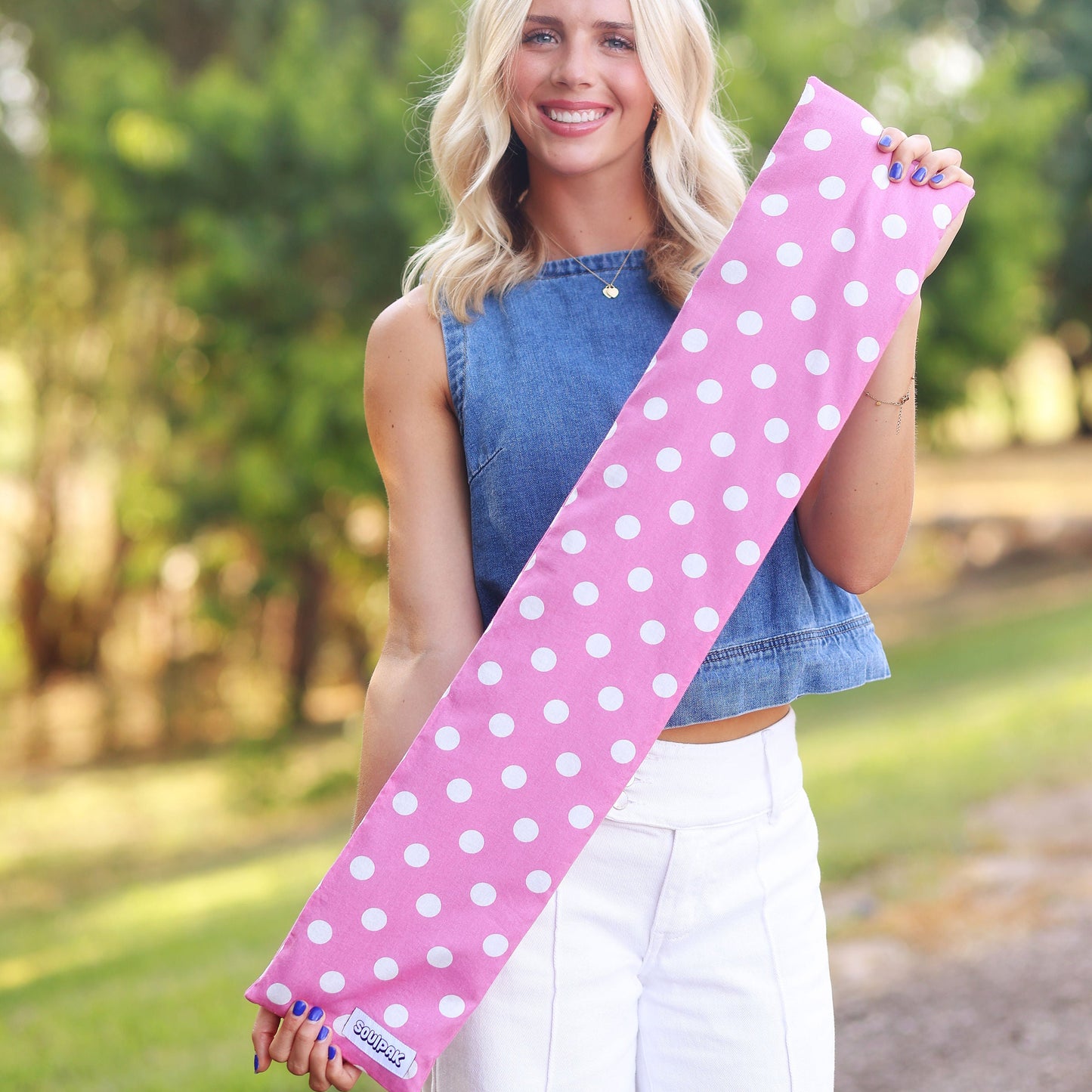 Long pink neck pad with white polka dots